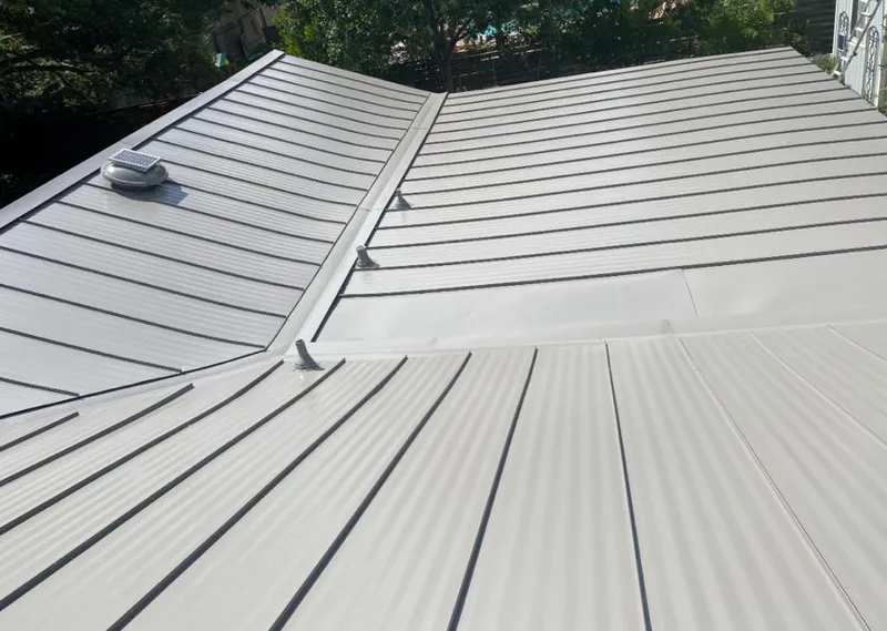 Solar attic fan installed on a metal roof for Roof Ventilation in Selma